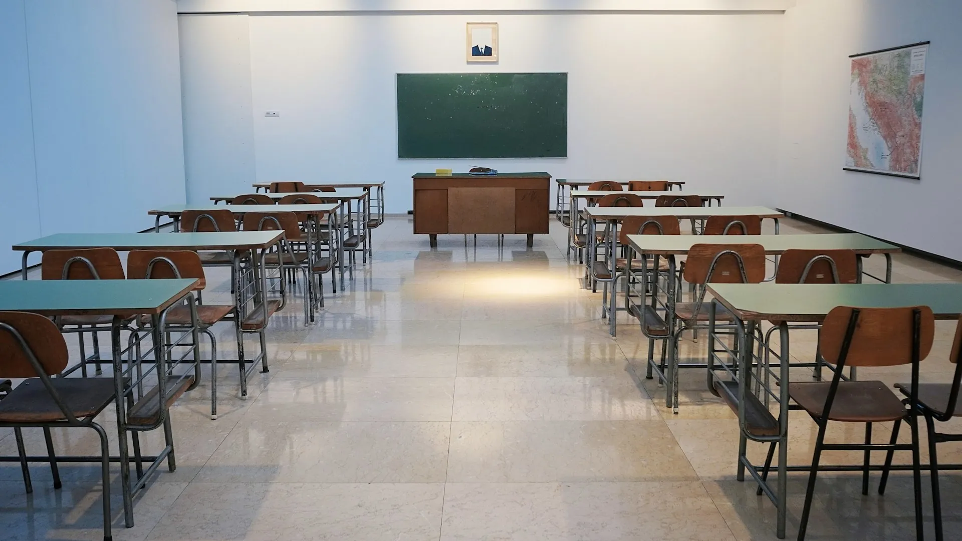 Empty classroom with desks and chalkboard — calm non-incident scene