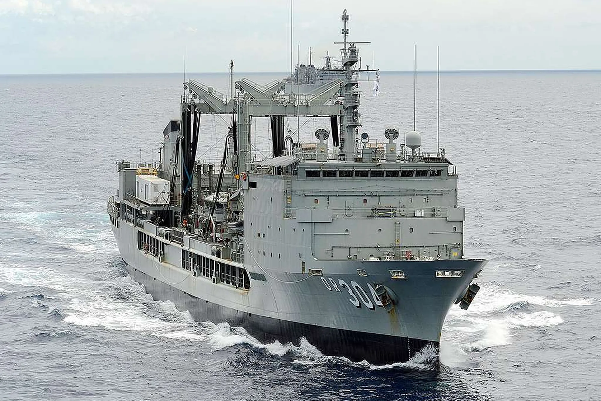 Grey-hulled supply ship under way in open water — calm non-incident scene